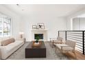Bright living room featuring a cozy fireplace, modern furniture, and hardwood floors at 3643 S Mobile Way, Aurora, CO 80013