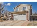 Inviting two-story home showcasing a brick facade and attached two-car garage with a well-maintained lawn at 18347 E Nassau Dr, Aurora, CO 80013