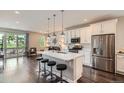 Bright kitchen featuring stainless steel appliances, white cabinetry and a spacious breakfast bar at 4343 E 96Th Way, Thornton, CO 80229
