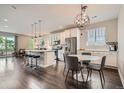 Open kitchen and dining area featuring modern stainless steel appliances and hardwood floors at 4343 E 96Th Way, Thornton, CO 80229