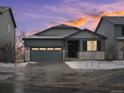 Charming single-Gathering home featuring a two-car garage, stone accents, and a well-manicured lawn at 1947 S Coolidge Way, Aurora, CO 80018