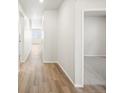 Bright hallway featuring wood floors leading to rooms with new carpet at 1947 S Coolidge Way, Aurora, CO 80018