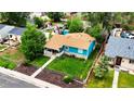 Aerial view of a charming property with a well-maintained lawn, quaint front porch, and mature trees at 377 N 10Th Ave, Brighton, CO 80601
