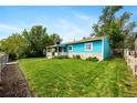 Well-maintained single-story home with a lush green lawn and inviting front porch at 377 N 10Th Ave, Brighton, CO 80601