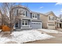 Charming two-story home with a covered front porch, shutters, and a two-car garage at 1963 Hogan Ct, Castle Rock, CO 80109