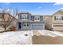 Charming two-story home with a covered front porch, shutters, and a two-car garage at 1963 Hogan Ct, Castle Rock, CO 80109