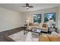 Inviting living room with hardwood floors, large windows, and comfortable seating arrangement at 3854 S Olathe Cir, Aurora, CO 80013