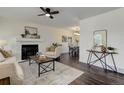 Open-concept living room featuring a fireplace and seamless transition to the dining area at 3854 S Olathe Cir, Aurora, CO 80013