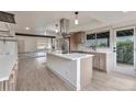 Well-lit kitchen with a large island, stainless steel appliances, and modern fixtures at 12164 E Amherst Cir, Aurora, CO 80014