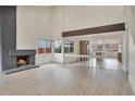 Bright open floor plan featuring a fireplace, laminate flooring, and a kitchen view at 12164 E Amherst Cir, Aurora, CO 80014