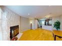 Spacious living room with stone fireplace and hardwood floors at 1811 S Quebec Way # 194, Denver, CO 80231