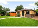 Charming single-story home with a lush green lawn, brick accents, and a welcoming front entrance at 2255 Perry St, Denver, CO 80212