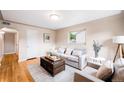 Cozy living room featuring hardwood floors, neutral decor, and comfortable seating arrangement at 2255 Perry St, Denver, CO 80212