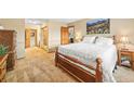 Bright bedroom featuring a large bed, plush carpet, and scenic mountain artwork at 10433 Red Mountain W, Littleton, CO 80127