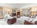 Cozy living room features a brick fireplace and sliding glass doors leading to the outside at 10433 Red Mountain W, Littleton, CO 80127