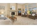 Cozy living room with a fireplace, large windows, and comfortable seating, perfect for relaxing and entertaining at 735 Orchard Ct, Louisville, CO 80027
