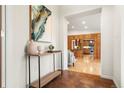 Inviting foyer with tile flooring, wood accents, and view to the living spaces beyond at 2020 Routt St, Lakewood, CO 80215
