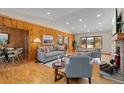 Spacious living room with hardwood floors, fireplace, and natural light at 2020 Routt St, Lakewood, CO 80215