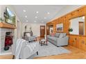 Inviting living room featuring wood paneling, a fireplace, and comfortable seating at 2020 Routt St, Lakewood, CO 80215