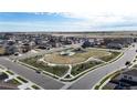 Aerial of the neighborhood park, surrounded by lovely houses, with a view of the open land beyond at 17947 E 95Th Ave, Commerce City, CO 80022
