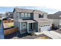 Attractive two-story home showcasing mixed siding, stone accents, a two-car garage, and a well-maintained landscaped yard at 17947 E 95Th Ave, Commerce City, CO 80022