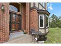 Inviting entryway with a wrought iron door and cozy seating area at 1972 Gold Camp Way, Franktown, CO 80116