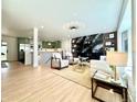 Bright open-concept living room featuring a fireplace and modern decor at 5563 E Jefferson Ave, Denver, CO 80237