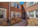 Close-up of brick apartment building with sidewalk and entry door at 2823 Jasmine St, Denver, CO 80207