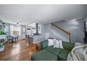 Inviting living room featuring hardwood floors and an open layout to the kitchen at 2823 Jasmine St, Denver, CO 80207