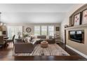 Inviting living room with hardwood floors, large windows, and a comfortable leather couch at 8216 S Tempe Ct, Aurora, CO 80016