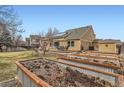 Large backyard with wood deck, garden beds, green grass and mature trees at 884 W 124Th Dr, Denver, CO 80234