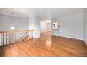 Open-concept living room with hardwood floors, staircase, and sight lines to the kitchen at 1244 S Wright St, Lakewood, CO 80228