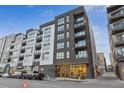 Modern building featuring a sleek facade with large windows and balconies, creating a vibrant urban living space at 1735 Central St # 208, Denver, CO 80211