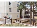 Apartment building with tidy landscaping, stairway leading up to the units, and mature shade trees at 9700 E Iliff Ave # G70, Denver, CO 80231