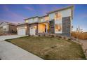 Stylish two-story home with modern architectural details and well-maintained front yard at 14373 Shasta Daisy Pt, Parker, CO 80134