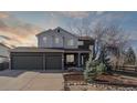 Beautiful home with a large three-car garage and well-maintained landscaping, including a small spruce tree and rock garden at 1534 Stanley Dr, Erie, CO 80516