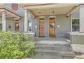 Inviting duplex entrances with classic doors, covered porches, brick columns, and manicured landscaping at 2564 N Emerson St, Denver, CO 80205