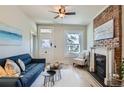 Cozy living room with a blue sofa, modern decor, a fireplace, and a bright window with a view at 2564 N Emerson St, Denver, CO 80205