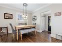 Bright dining room featuring hardwood floors, modern lighting, and stylish decor at 3176 Depew St, Wheat Ridge, CO 80214