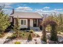 A quaint home with manicured garden and a welcoming front entrance at 3176 Depew St, Wheat Ridge, CO 80214