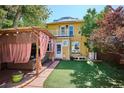 Expansive backyard featuring a covered patio, lush lawn, and well-maintained landscaping at 263 N Logan St, Denver, CO 80203