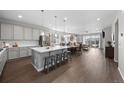 Open concept kitchen with gray cabinets, stainless steel appliances, and a large island with seating for entertaining at 3575 White Rose Loop, Castle Rock, CO 80108
