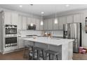 Beautiful kitchen with gray cabinetry, stainless appliances, large island, and stylish backsplash, perfect for cooking at 3575 White Rose Loop, Castle Rock, CO 80108