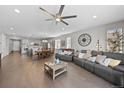Spacious open-concept living area with hardwood floors, lots of natural light, with kitchen and dining areas at 3575 White Rose Loop, Castle Rock, CO 80108