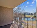 Serene balcony view overlooking a pond, golf course, and lush greenery on a sunny day at 13618 E Bethany Pl # 306, Aurora, CO 80014