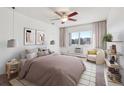 Bright bedroom featuring a ceiling fan, large window with natural light, and comfortable seating area at 13618 E Bethany Pl # 306, Aurora, CO 80014