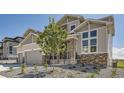 Attractive two-story home showcasing a well-manicured front yard, complemented by stone details and a welcoming entrance at 4769 Weitbrec Ln, Castle Rock, CO 80104