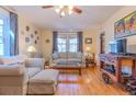 Bright living room with hardwood floors, neutral furniture, large windows, and a ceiling fan at 1436 N Gilpin St # 2, Denver, CO 80218