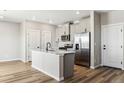Modern kitchen with a center island, stainless steel appliances, and ample counter space at 9454 Yampa St, Commerce City, CO 80022