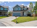 Charming two-story home with an attached two-car garage, well-kept lawn, and traditional curb appeal at 12277 Krameria St, Brighton, CO 80602